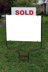 Wall Mural - Real estate SOLD sign embedded in lawn with white copy space.