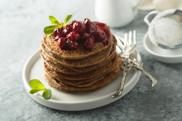 Wall Mural - Homemade chocolate pancakes with cherry sauce