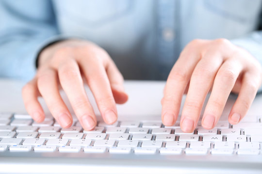 Female hands typing on computer keyboard