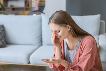 Poster - Sad young woman with wedding ring at home. Concept of divorce