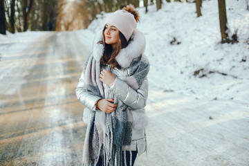 Wall Mural - young pretty girl in winter park