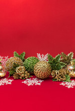 Golden, Green, White Xmas Decorative Balls, Snowflakes, Flowers On Red Background For Greeting Card Design With Free Space For Text