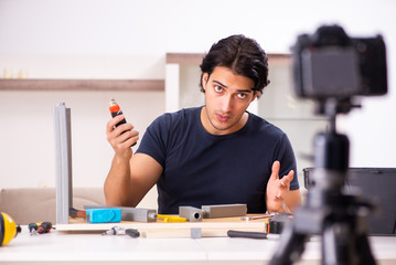 Young male repairman recording video for his blog