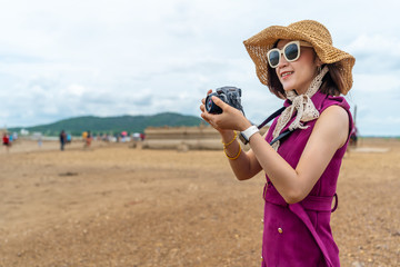 Wall Mural - traveller woman taking a photo with camera