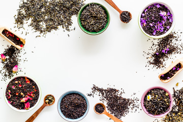 Wall Mural - Dry leaves of herbal tea frame on white background top view mockup