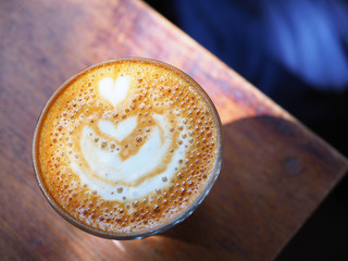 Wall Mural -  Hot coffee with heart shape in glass cup on wooden table.