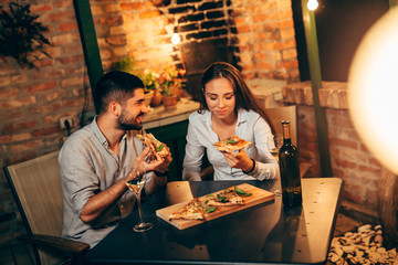 Wall Mural - friends eating pizza at home garden, night scene