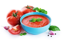 Bowl Of Tomato Soup, Tomatoes, Garlic And Basil  Isolated On A White Background.