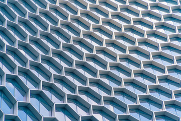 Poster - Office buildings. Structure of hexagon windows in futuristic technology network connection concept. Blue glass modern architecture facade design with reflection of sky in urban city, Downtown.