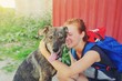 © raisondtre - Portrait young hipster woman with backpack kissing dog outdoors Happy pet and attractive girl playing fun Positive human emotions, facial expression, feelings Friendship hug between owner and animal