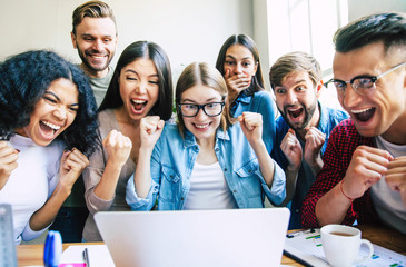 Wall Mural - Modern happy start up team in casual clothes in office or co-working space are working and discussion them plans and ideas.