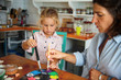 © Stock Rocket - Mother and daughter painting Christmass ornaments