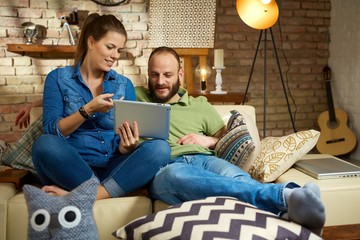 Sticker - Young couple at home using tablet