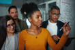 © StratfordProductions - Multi-ethnic group of business people planning startup project on glass board in office