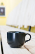 Black Coffee mug on wooden table in coffee shop