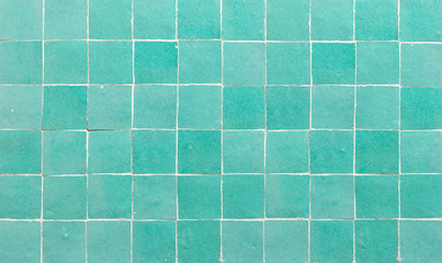 Wall Mural - Old retro azure green ceramic tile texture background. Azure green square tiled wall.