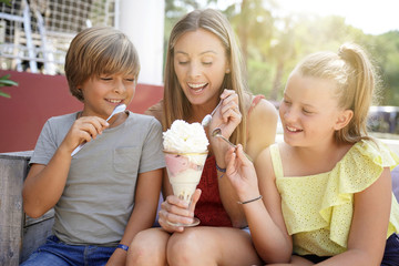 Mother and kids eating ice cream