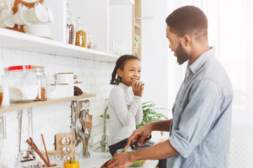 Wall Mural - African father and his little girl preparing food