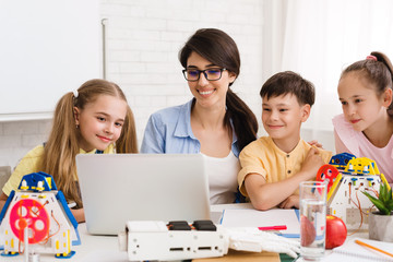 Poster - Teacher showing scientific robotics video to children