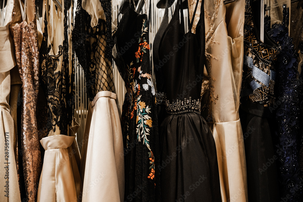 Luxurious evening night out sparkling dresses hanging on the rack. High fashion concept, haute couture, designer  - obrazy, fototapety, plakaty 