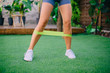 © MZaitsev - Close up woman is exercising with resistant band on lawn