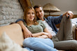 © BGStock72 - Smiling young couple relaxing and watching TV at home