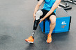 © karrastock - Disabled athlete assembling his leg prosthesis in the gym. Paralympic Sport Concept.