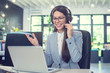 © Bojan - Beautiful friendly call center agent woman with headset using laptop and talking to a client via online customer support service