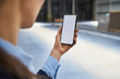 © Westend61 - Close-up of businesswoman holding cell phone in factory