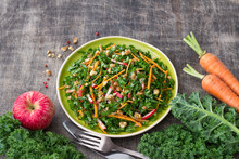 Healthy Cabbage Kale Salad With Carrots, Apple And Walnut On Wooden Background. Delicious Homemade Diet Food