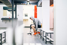 Athlete Man With Prosthetic Leg In Gym Locker Room Preparing To Train