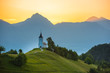 saint primož Church on the hill at sunrise. Beautiful scenery at Jamnik, Slovenia. Panoramic view of the mountains behind the church