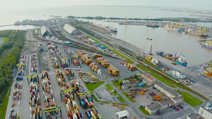 Wall Mural - Panoramic aerial top view from the heights of the cityscape port harbor and industrial area, container warehouse and railway system network leading to the seaport