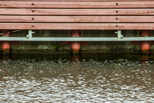 Maroon Vertical Wooden Slats On The Background Of The River