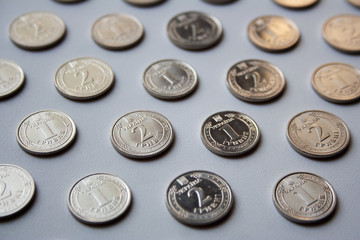 Ukrainian coins pattern of one hryvnia and two hryvnias value on white background