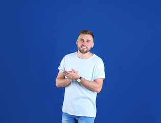 Poster - Portrait of handsome happy man on color background