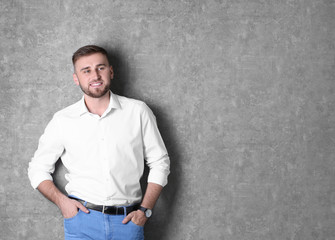 Wall Mural - Portrait of handsome happy man on grey background, space for text