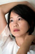 © Kenishirotie - Portrait young Asian woman indoor looking away
