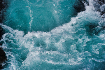 Wall Mural - bruarfoss waterfall in iceland as an abstract of the blue water and whitewater from above