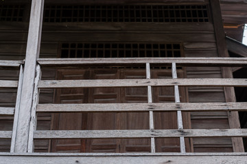 Wall Mural - Antique old wooden balcony of rural house in Thailand