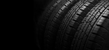 Studio Shot Of A Set Of Summer Car Tires On Black Background With Copy Space.