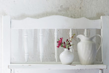 Flowers In White Vase On Old Wooden Shelf