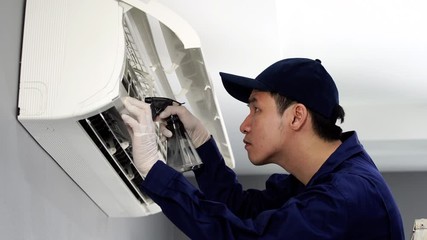 Wall Mural - technician service cleaning the air conditioner indoors