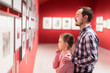 © JackF - Man and girl exploring exhibition of photos