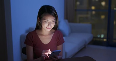 Canvas Print - Woman use of mobile phone at home in the evening