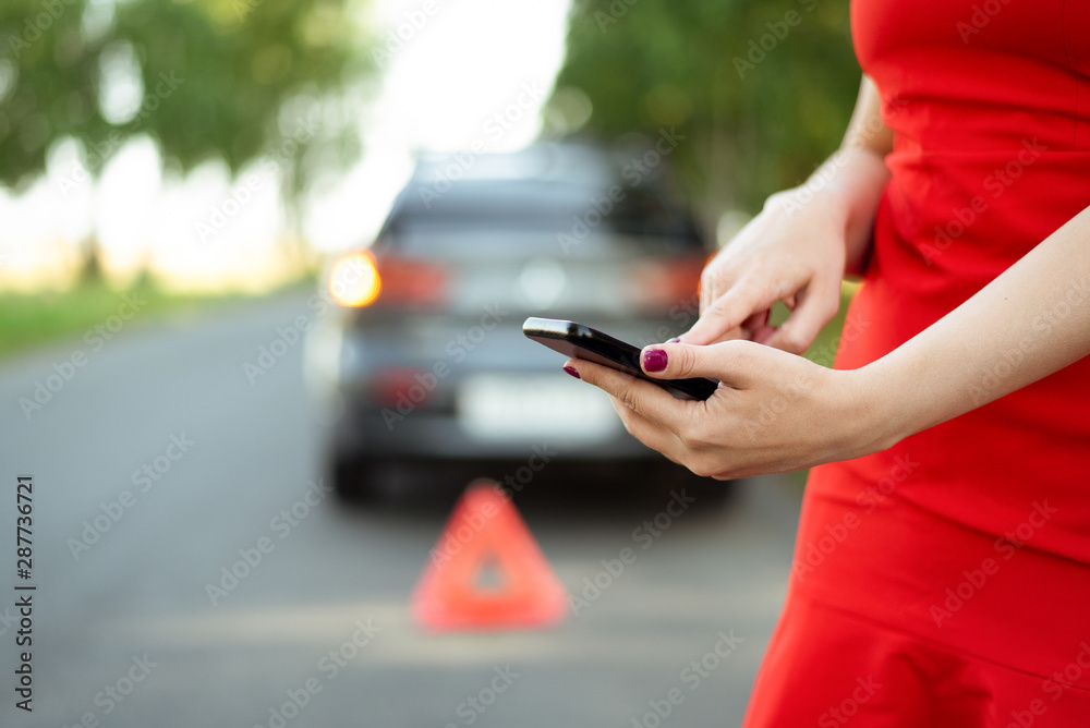 Woman needs help with her broken car and is calling on mobile phone to ...