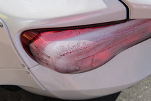 White Sports Car Closeup. Problems With Rear Lights. Fogged Up Backlight. Condensation In Taillights. Repairs Needed.