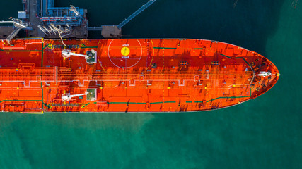 Wall Mural - Red tanker ship loading and unloading oil and gas at industrial port, Business import export petrochemical oil and gas by tanker ship transportation.