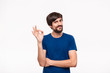 © ianachyrva - Handsome brunet bearded man with mustaches in a blue shirt showing gesture of OK sign standing isolated over white background. OK gesture.