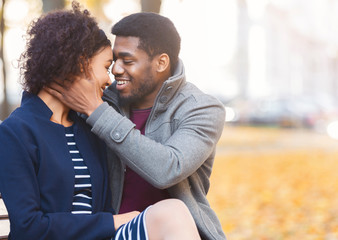 Wall Mural - African american man embracing his woman, saying sweet words